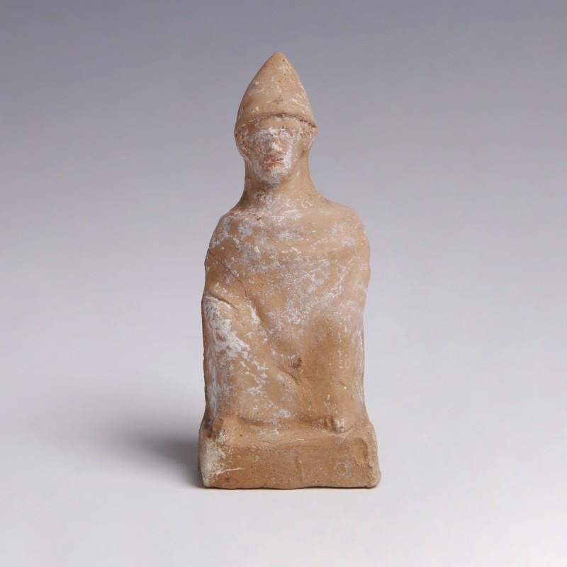 A Greek Terracotta Figurine of a Seated Man A Greek Terracotta Figurine of a Seated Man
