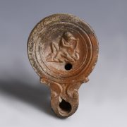 A Roman Oil Lamp with Ithyphallic Man
