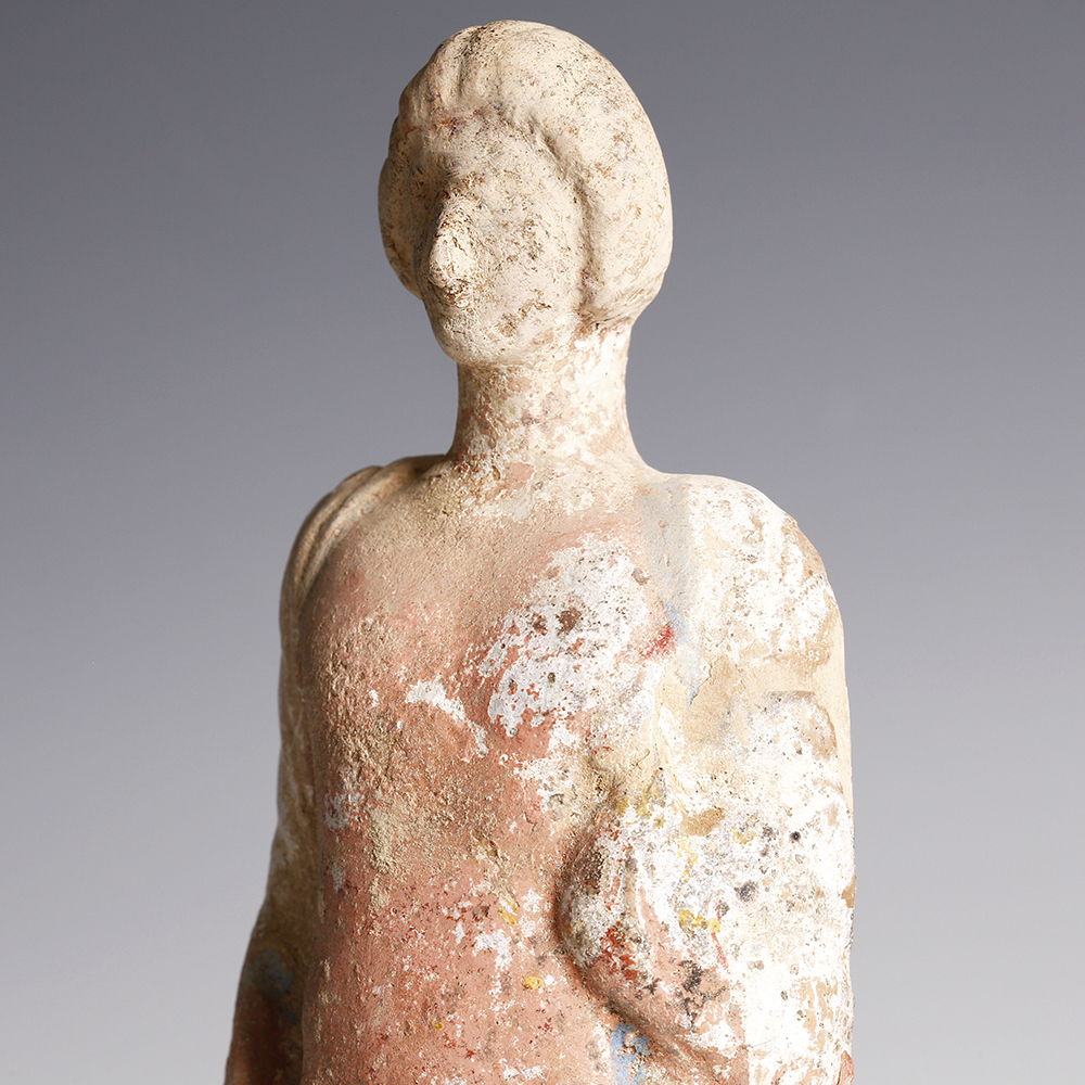 A Greek Terracotta Statuette of a Young Man A Greek Terracotta Statuette of a Young Man