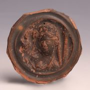 Ancient Greek Black-Glazed Terracotta Roundel with a Woman