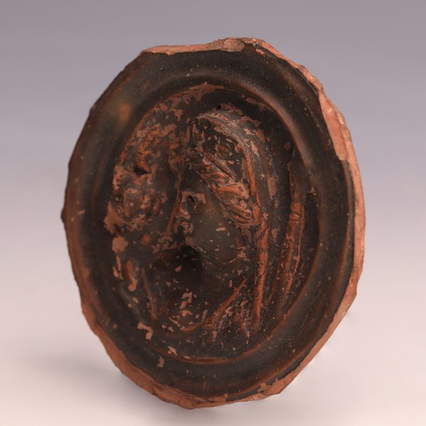 Ancient Greek Black-Glazed Terracotta Roundel with a Woman